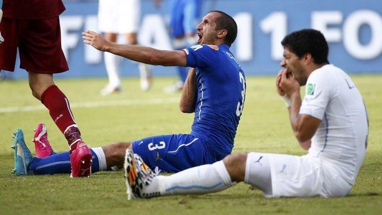 Italian defender Giorgio Chiellini and Luis Suarez shortly after clashing. 25/06/2014