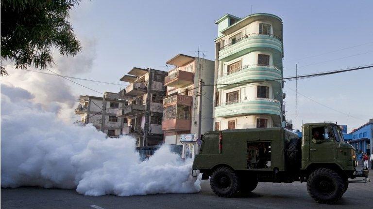 A military truck fumigates against a mosquito-borne virus in Havana on 24 June, 2014