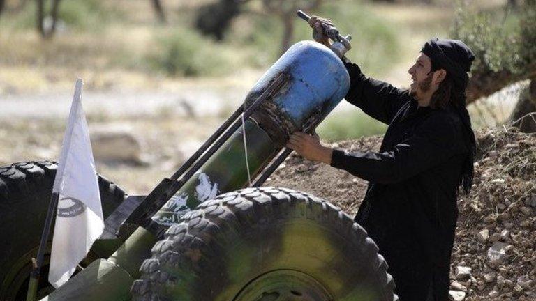 A Free Syrian Army fighter loading a weapon