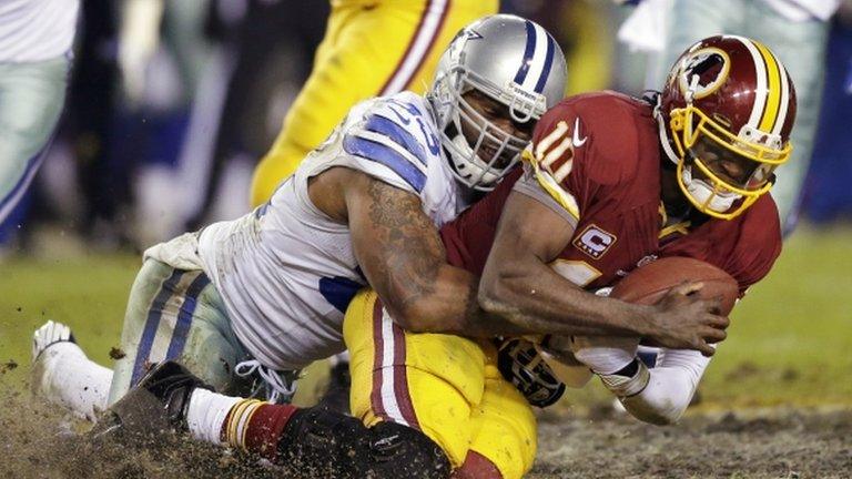 Dallas Cowboys outside linebacker Anthony Spencer (left) sacked Washington Redskins quarterback Robert Griffin III, in Landover, Maryland, on 30 December 2012