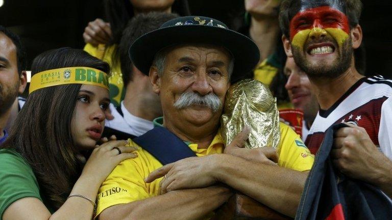 Brazil fan holds the World Cup trophy during the 7-1 semi-final defeat by Germany