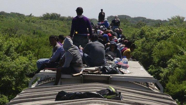 Unaccompanied minors ride atop the wagon of La Bestia (The Beast) in Ixtepec on 18 June, 2014.