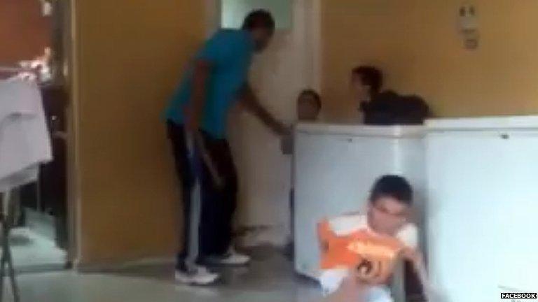 Still of the video showing a Egyptian man beating young orphans