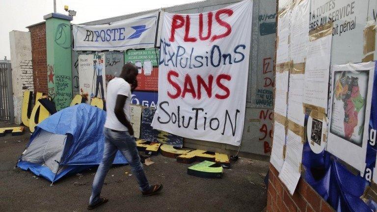 A migrant goes inside in a squat opened by activists from the No Borders UK network in a former recycling factory in Calais August