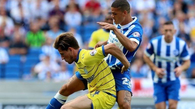 Brighton's Shamir Fenelon and Sam Hutchinson (l) battle for possession