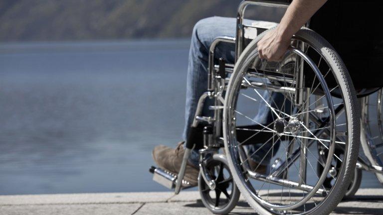 Man in a wheelchair by water