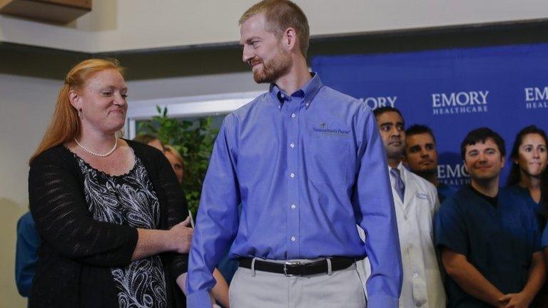 Ebola virus survivor Dr. Kent Brantly (C) and his wife, Amber (L) arrive at news conference at Emory University Hospital in Atlanta, Georgia 21 August 2014