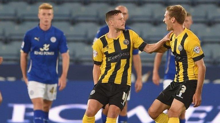 Andrew Mangan (left) of Shrewsbury pulls up injured while celebrating