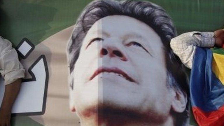 Supporters of Imran Khan, the Chairman of the Pakistan Tehreek-e-Insaf (PTI) political party, take a nap on Khan"s campaign banner during what has been dubbed a "freedom march" in Islamabad August 25, 2014.