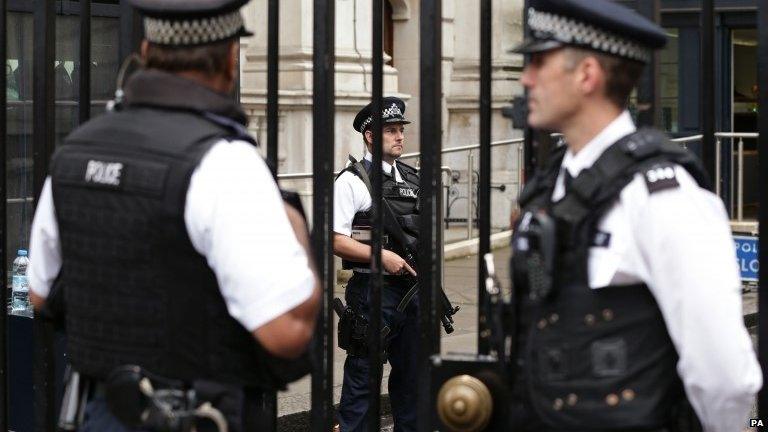 Armed police officers on duty at Downing Street, London