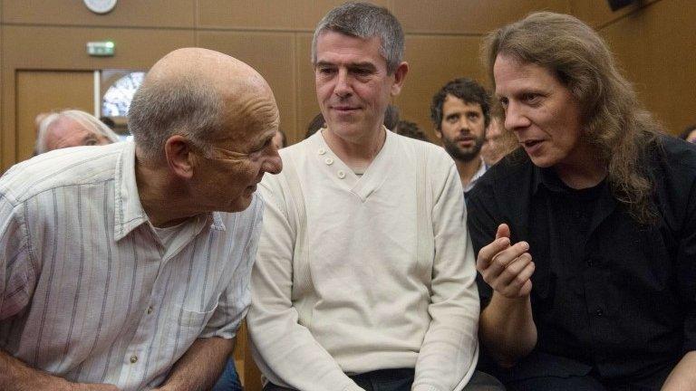 Greenpeace activists Peter Wentt (L), Jean-Michel Vougere (C) and Eddy Varin (R) talk in a courthouse in Colmar, eastern France, 4 September