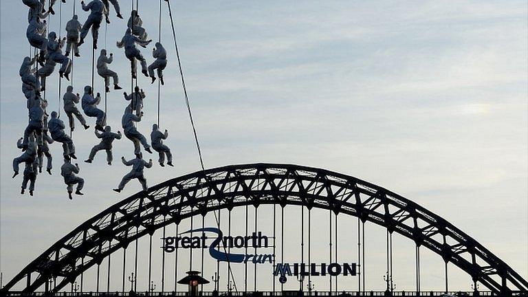 Performers near the Tyne Bridge for the Great North Run millionth finisher event