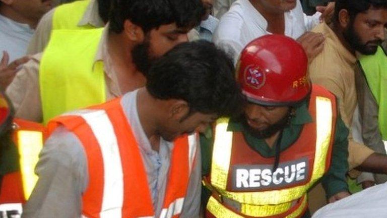 Pakistani rescue workers at the mosque in Lahore on September 9, 2014.