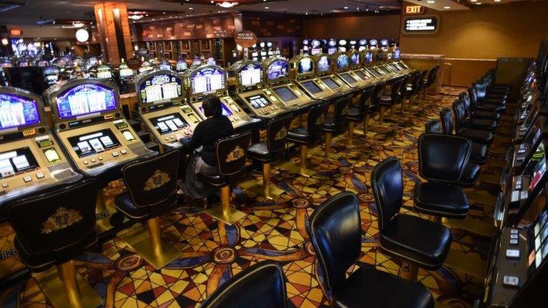 A woman plays the slot machines at Trump Plaza Casino in Atlantic City, New Jersey 15 September 2014