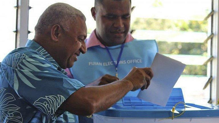 Fiji's military ruler Voreqe Bainimarama, left, casts his vote in a national election in Suva, Fiji, 17 September 2014