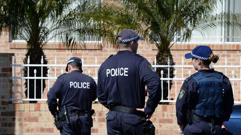 New South Wales Police and Australian Federal Police officers raid a house in Sydney, Australia, on 18 September 2014