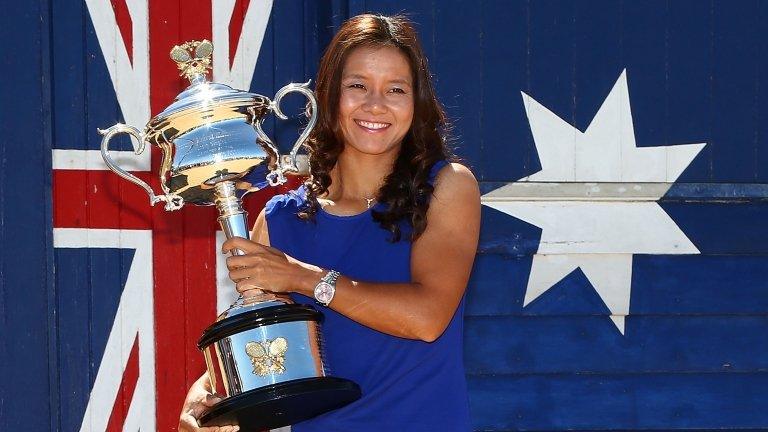 Li Na poses with the Daphne Akhurst Memorial Cup at Brighton Beach, after winning the 2014 Australian Open, on 26 January 2014 in Melbourne, Australia