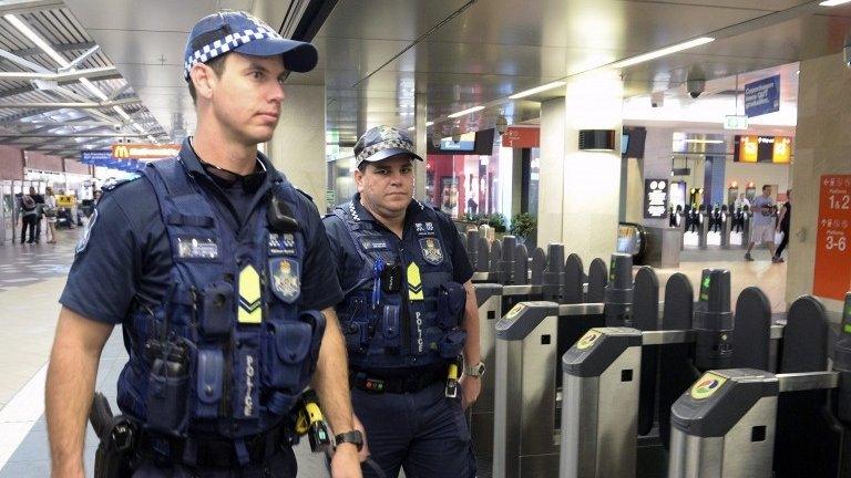 Police officers patrol Central rail station in Brisbane, Queensland, Australia, 15 September 2014.