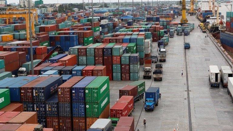 Workers are seen among the containers at Asia World port in Yangon