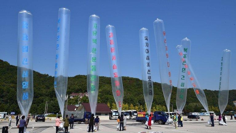 South Korean activists prepare to release balloons carrying anti-North Korea leaflets at a park near the inter-Korea border in Paju, north of Seoul, on 10 October 2014