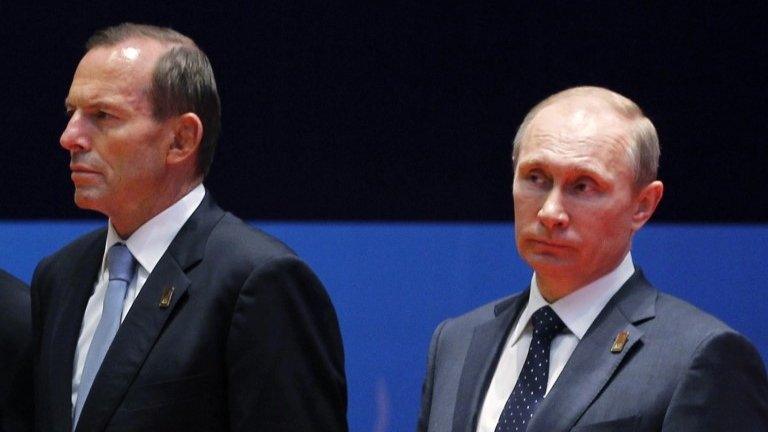 In this 8 Oct 2013 file photo, Australian Prime Minister Tony Abbott, left, and Russian President Vladimir Putin listen to a speech during the leaders' press conference at the Asia-Pacific Economic Cooperation (APEC) forum in Bali, Indonesia.