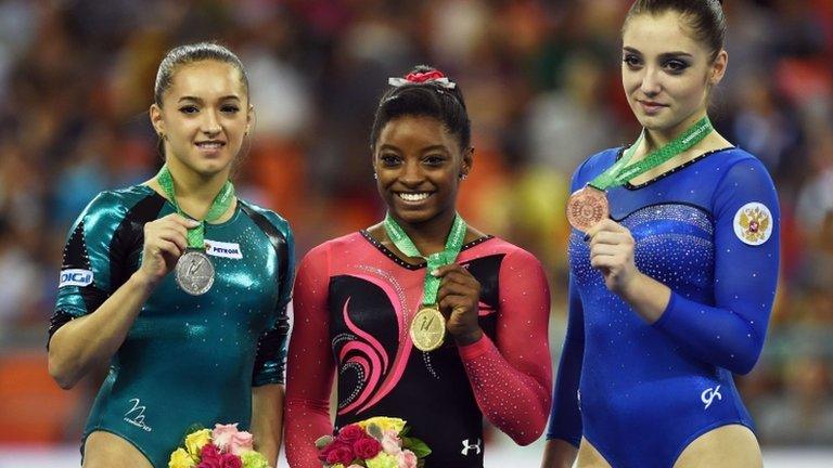 (l-r) Romania"s Larisa Andreea Iordache, Simone Biles and Russia"s Aliya Mustafina