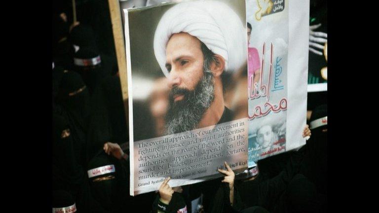 Shia women protesters hold a poster of Sheikh Nimr Baqir al-Nimr at the funeral of three people killed at a demonstration following his arrest (30 September 2012)