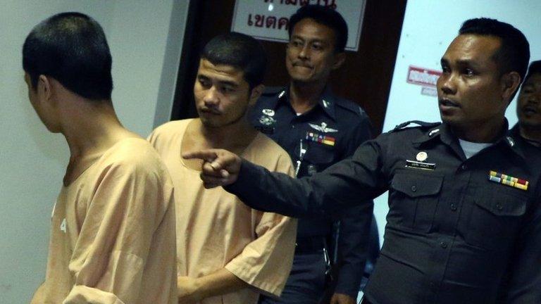 A photo made available on 15 October 2014 shows two Myanmar migrant workers Win (L) and Saw (L-2), suspects in the killing of two British tourists, are escorted by police officers as they leave Koh Samui Provincial Court in Surat Thani province, southern Thailand