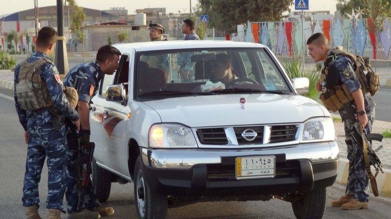 Iraqi security forces man a checkpoint in the northern city of Kirkuk, 1 October 2014