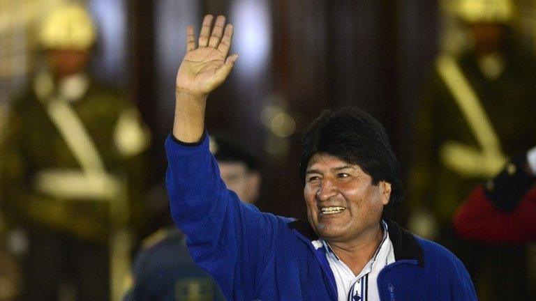 Evo Morales waves to supporters outside the Presidential Palace in La Paz on 12 October, 2014