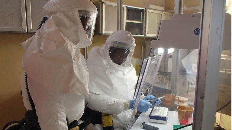 Workers testing in an Ebola lab.