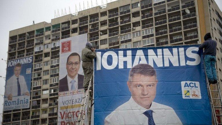 A poster of Victor Ponta between two of his rival Klaus Iohannis in Bucharest, 14 November