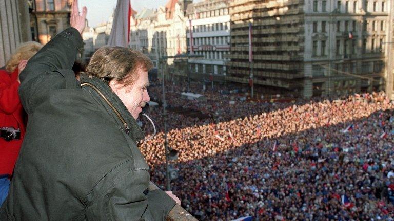 Vaclav Havel waves to the crowd of thousands of demonstrators gathered on Prague's Wenceslas Square