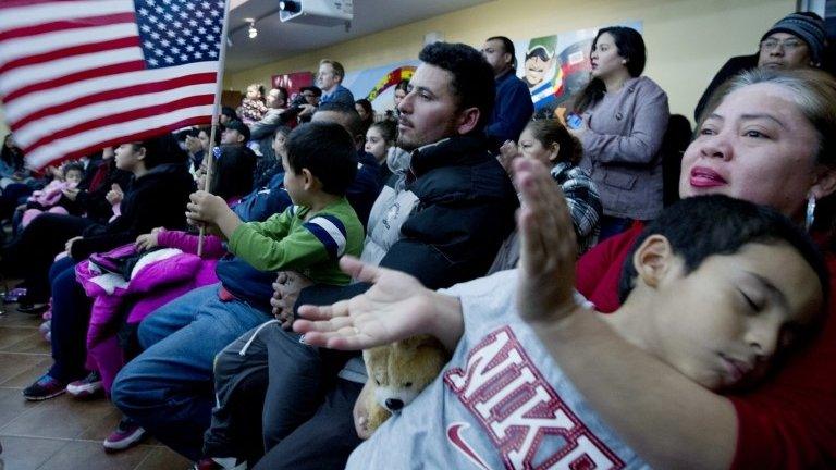 Alicia Silva applauds during President Barack Obama's televised immigration speech in Hyattsville, Nov 20