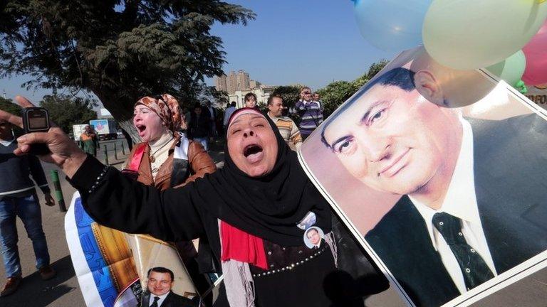 Mubarak supporters celebrate after the verdict outside the Cairo military hospital where he is being held, 29 November