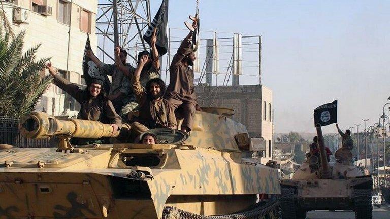 Islamic State militants drive a tank through Raqqa, Syria (undated image)