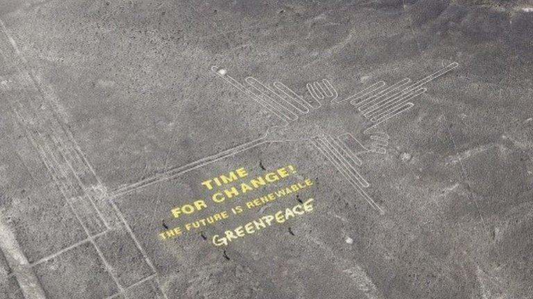 A climate change banner is seen beside the Nazca lines located on a stretch of coastal desert in Peru, in this handout photo released on 8 December 2014, by Greenpeace