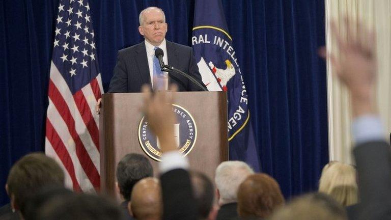 Members of the media raise their hands during CIA Director John Brennan's news conference at CIA headquarters in Langley, Virginia 11 December 2014