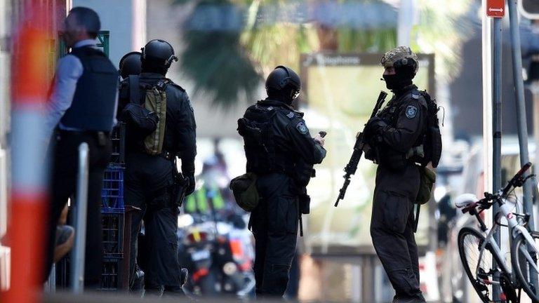 Members of the New South Wales (NSW) Police Force Public Order and Riot Squad (PORS) are seen outside a Lindt cafe in Martin Place in the central business district of Sydney, Australia, 15 December 2014