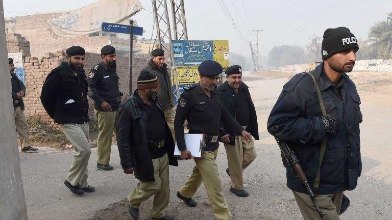 Pakistani police search around the school in Peshawar, 21 December