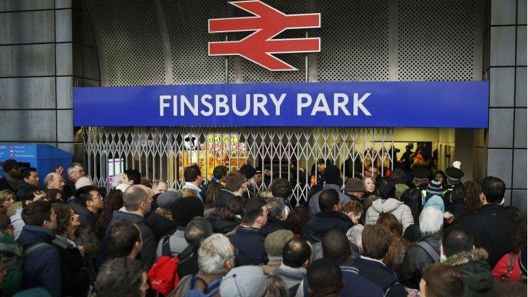 Crowds of passengers queue outside Finsbury Park Station in north London