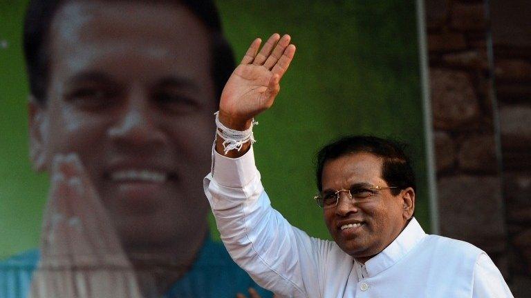 This file photo taken on November 30, 2014 shows Sri Lanka"s main opposition presidential candidate Maithripala Sirisena waving to the crowd during an election rally in the north-central town of Polonnaruwa.