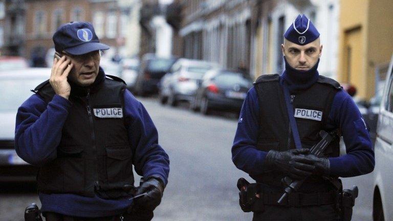 Policemen stand guard at Colline street in Verviers, eastern Belgium, 16 January 2015