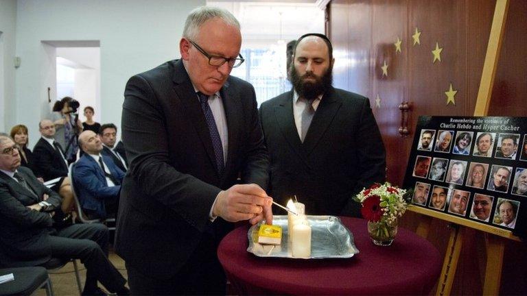 Vice-President of the European Commission Frans Timmermans, left, lights a memorial candle during a memorial service at the European Jewish Association in Brussels, 21 January