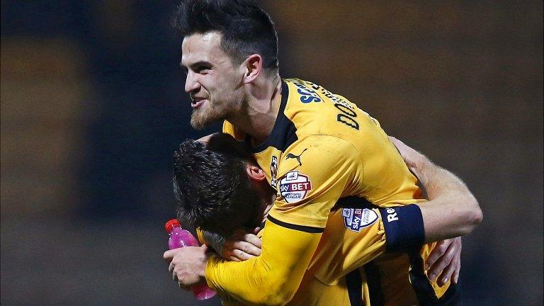 Cambridge United's Ryan Donaldson (top) celebrates with Tom Champion at the final whistle