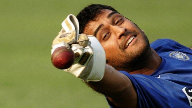 In this photograph taken on November 28, 2007, Indian wicketkeeper Mahendra Singh Dhoni tries to catch a ball during a training session at The Eden Gardens Stadium in Kolkata,