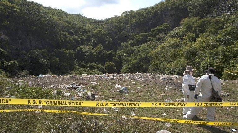 File picture taken 28 October 2014 showing forensic experts working in a dumpster where allegedly where burnt the bodies of the 43 missing students of Ayotzinapa, Guerrero state, Mexico