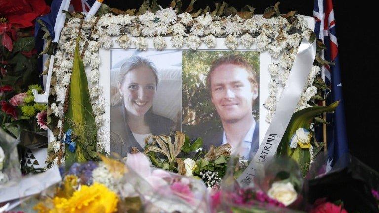 Photographs of Katrina Dawson and Tori Johnson are displayed in a floral tribute near the site of the siege in Sydney's Martin Place, 23 December 2014.