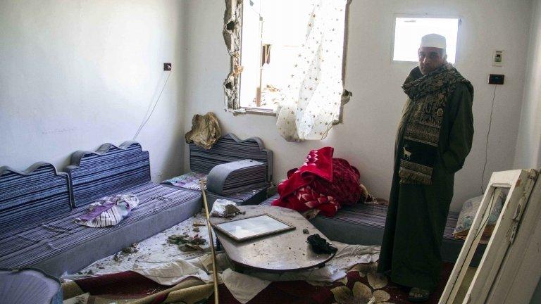 An Egyptian stands in a room heavily damaged in one of the attacks