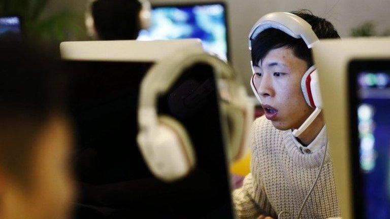 People use computers in an internet cafe in Beijing, China, 27 January 2015